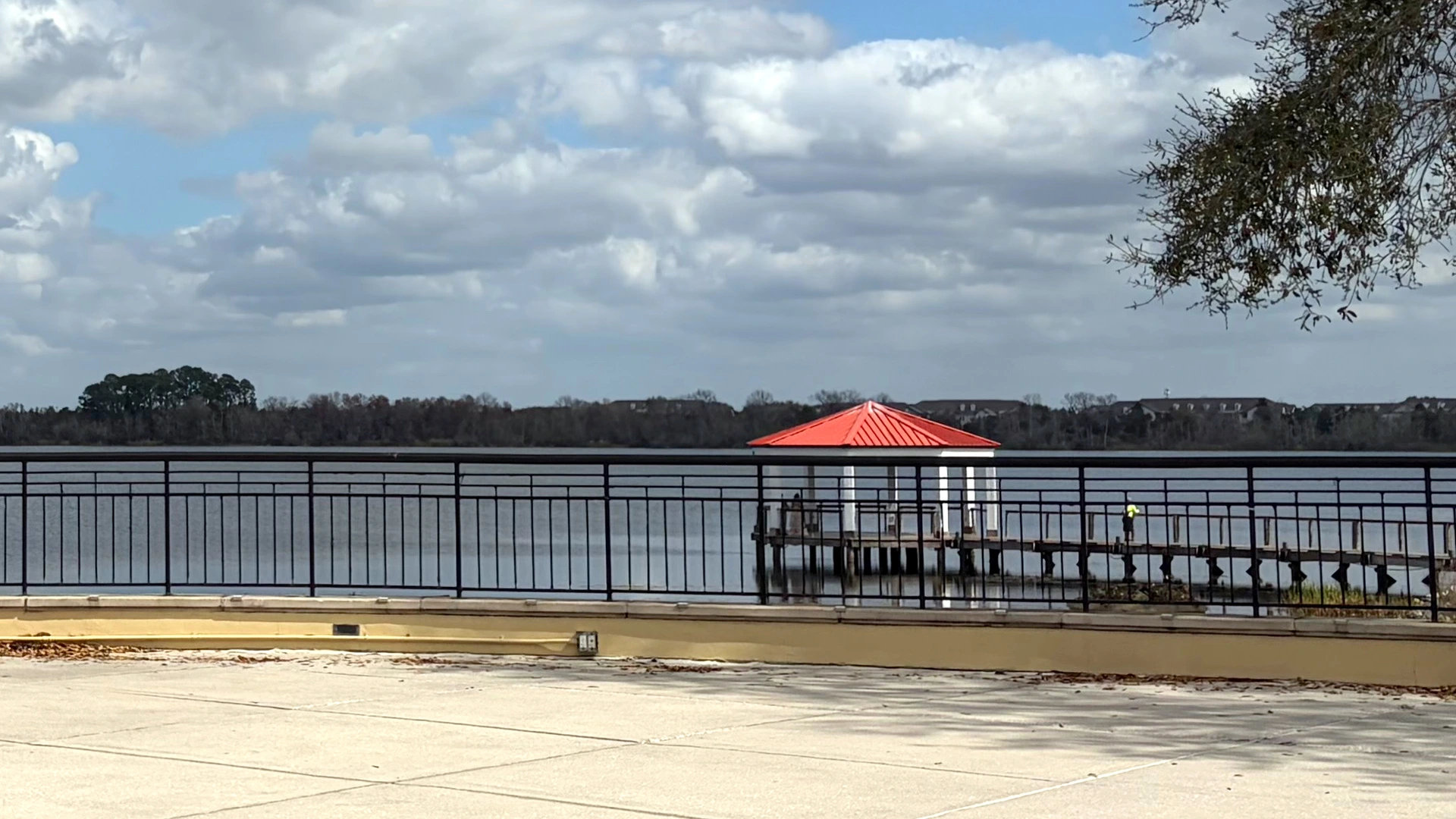 Lakeside railing and a red-roofed dock on the water in Baldwin Park